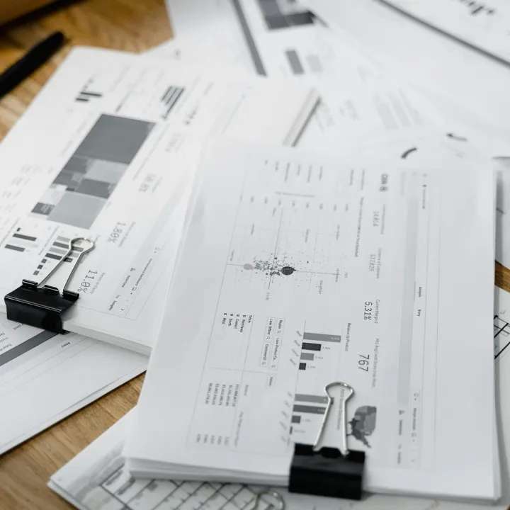Detailed architectural blueprints and measuring tools laid out on a table, representing strategic planning.