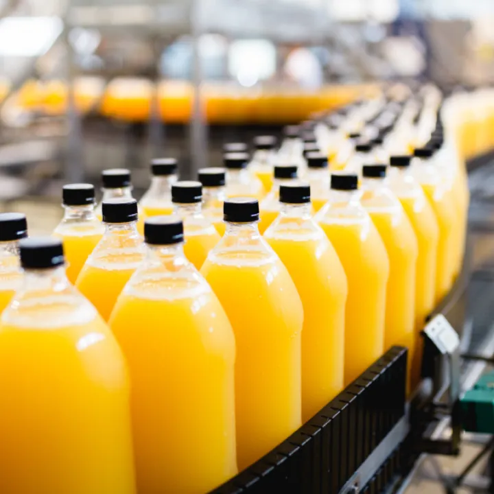 Rows of yellow liquid in industrial containers, illustrating the concept of mass production and efficiency.